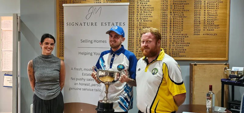 Aaron Furzer receives the Stirling Area and District Champion of Champions trophy following his 21–19 victory over James Wray, alongside the event sponsor and his opponent.