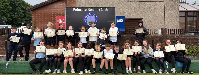 Fallin Primary School pupils proudly pose outside Polmaise Bowling Club holding their participation certificates after enjoying their Try Bowls session