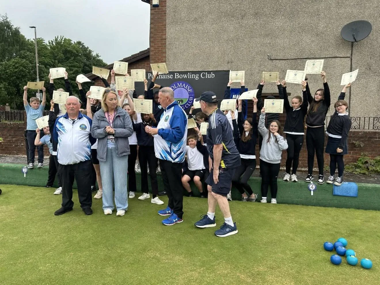 Club Secretary Peter Black and President David Stewart hand Fallin Primary School Head Teacher Mrs Brennan a £425 donation from Polmaise Bowling Club