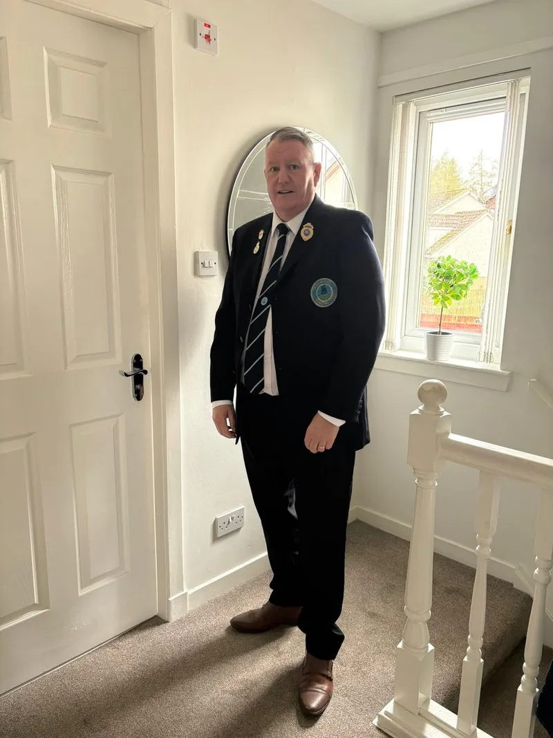 President of Polmaise Bowling Club, David Stewart, preparing for the opening of the green.