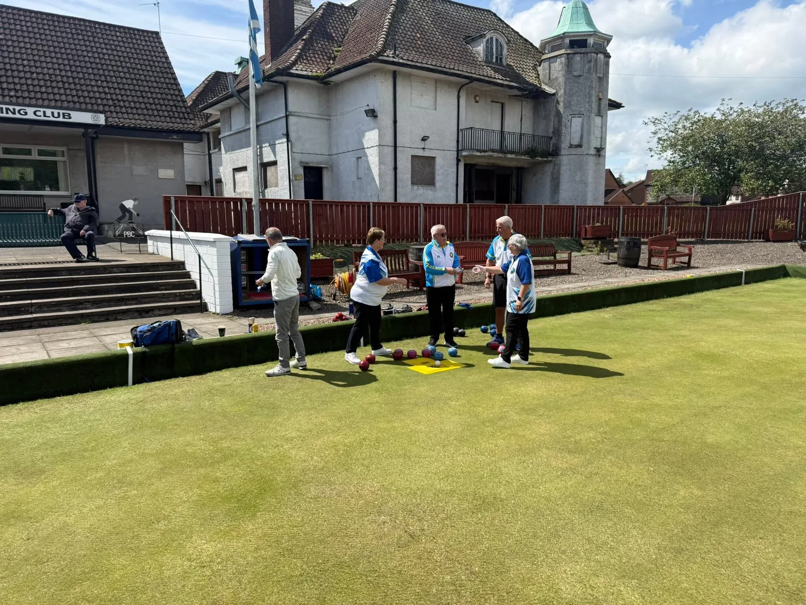 Polmaise and Patons & Baldwins players on the green during the centenary friendly