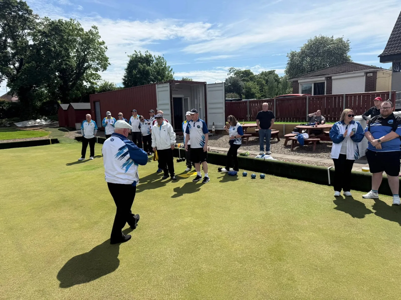 Players applaud on the green at Patons & Baldwins Bowling Club